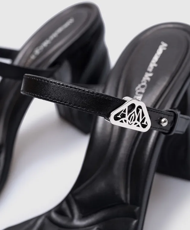 Alexander McQueen Seal black leather mules with metal logo patch